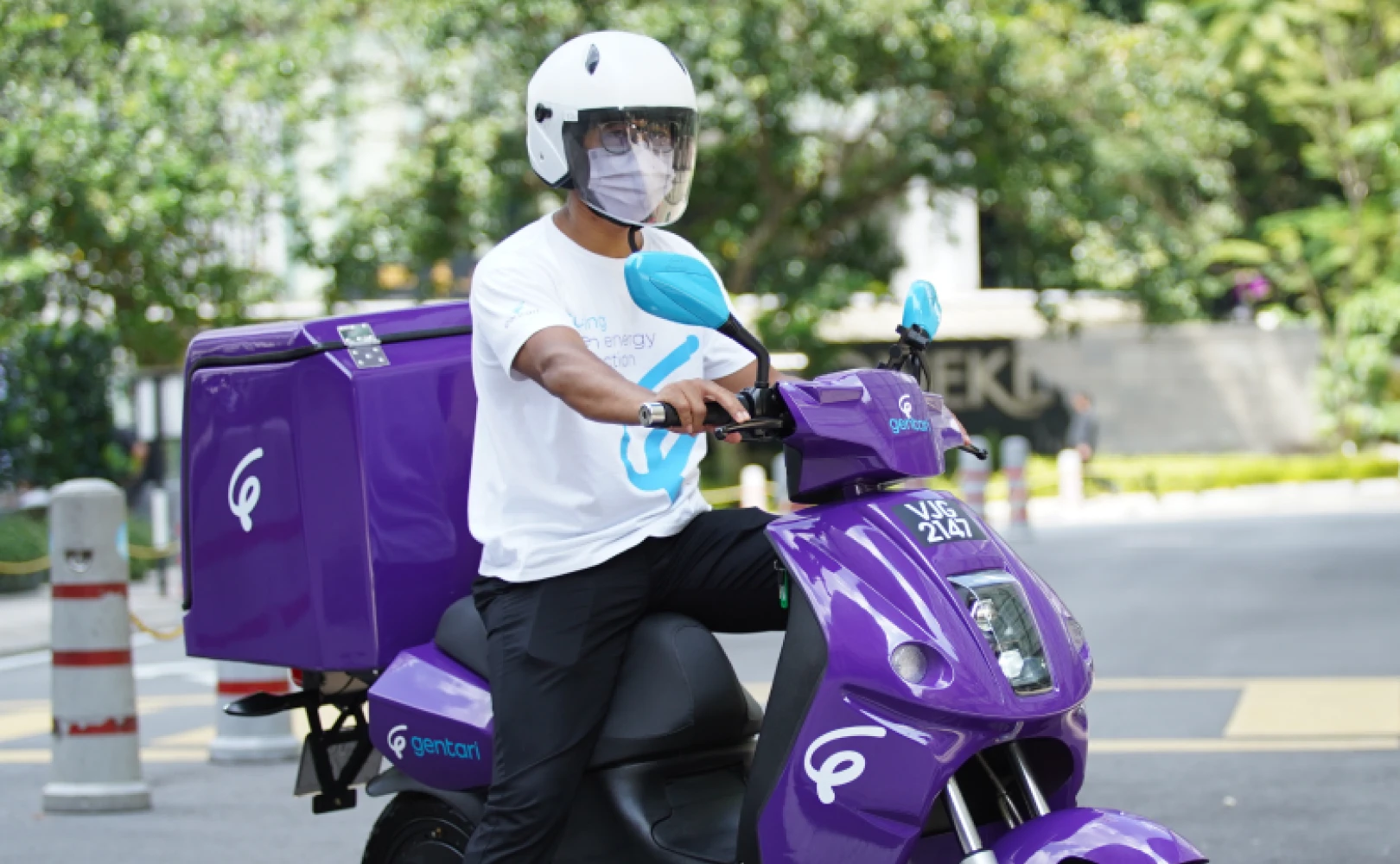 Rider on an electric motorcycle, representing Gentari's role in promoting sustainable transport electric fleet solutions