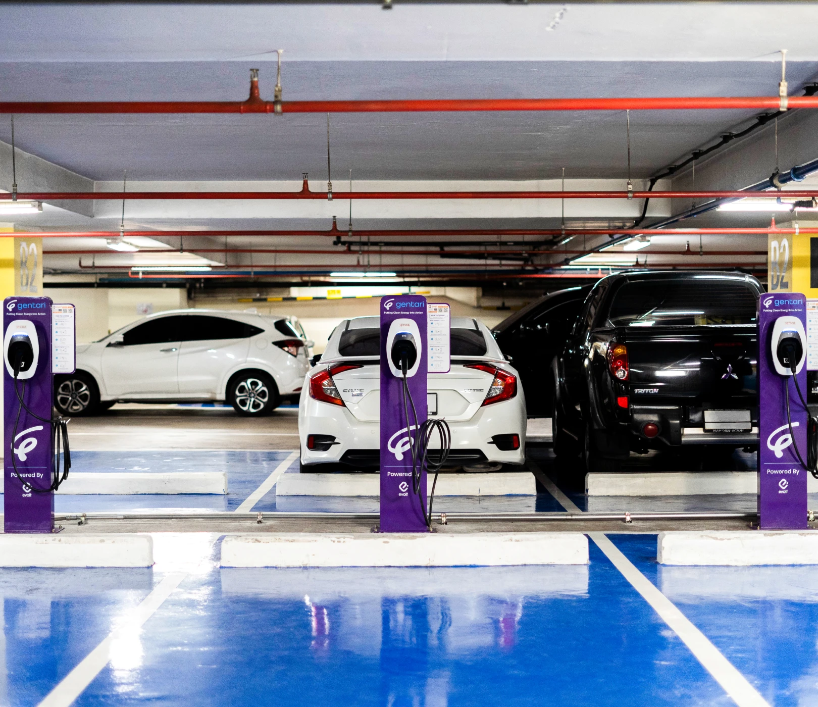 Car charging at EV station: Gentari drives Thailand's green mobility with extensive EV networks and public education, aligning with national environmental goals