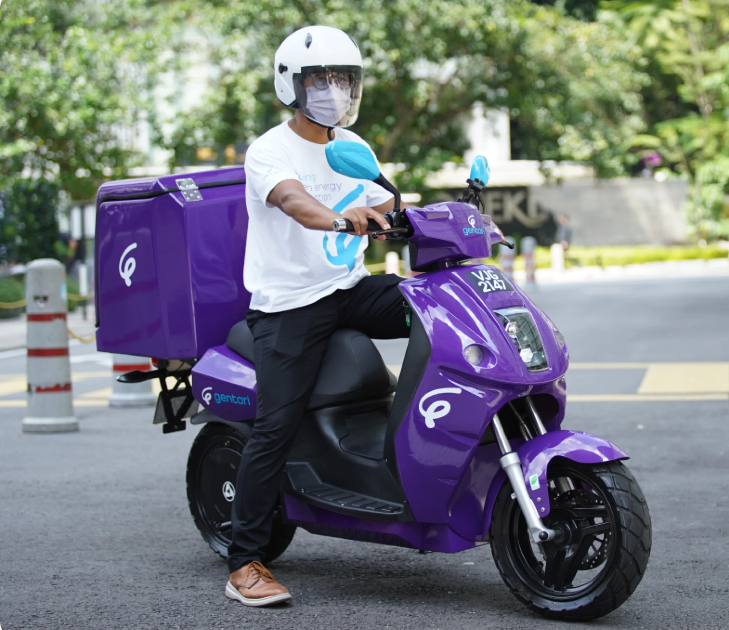 Rider on an electric motorcycle, representing Gentari's role in promoting sustainable transport electric fleet solutions